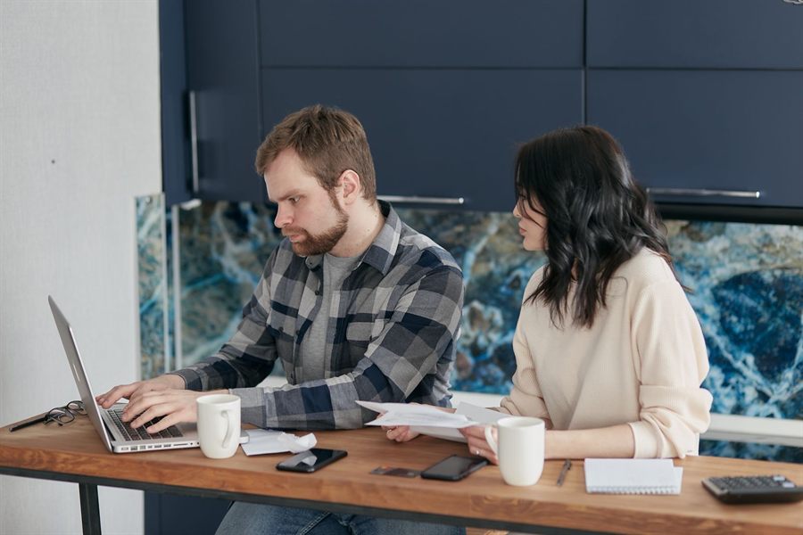 Couple comparing travel plans on a laptop